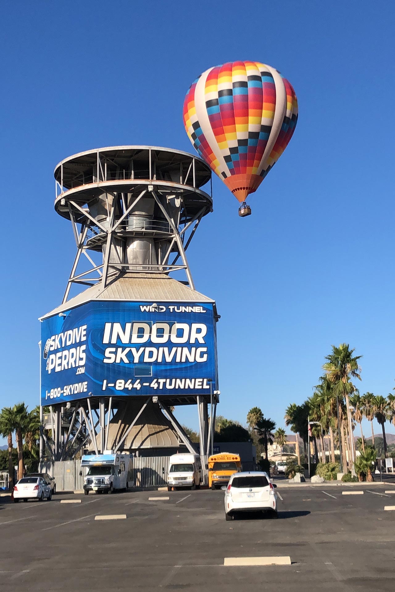 Hot air balloon beside an exterior view of the wind tunnel at Skydive Perris